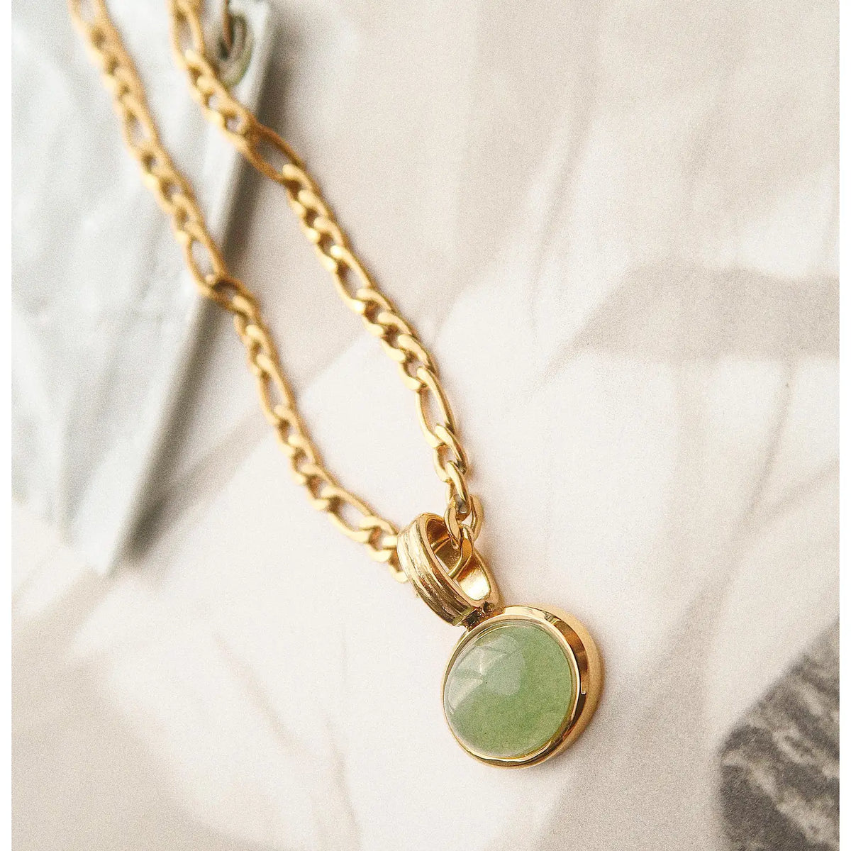Non-Tarnish Green Stone Pendant Chain Necklace  • Stainless Steel • Green Gemstone • 18k Gold Chain • Pendant Size (inch): 0.5 x 0.4 • Chain Length (inch): 15 • Extension Length (inch): 2"  • Lead-free, Nickel-safe • Hypoallergenic • Water Resistant